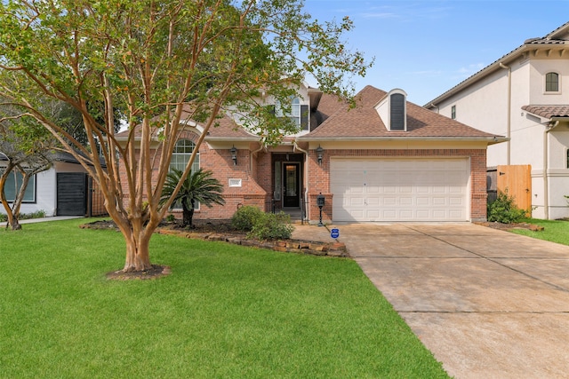 view of front of home with a front yard and a garage