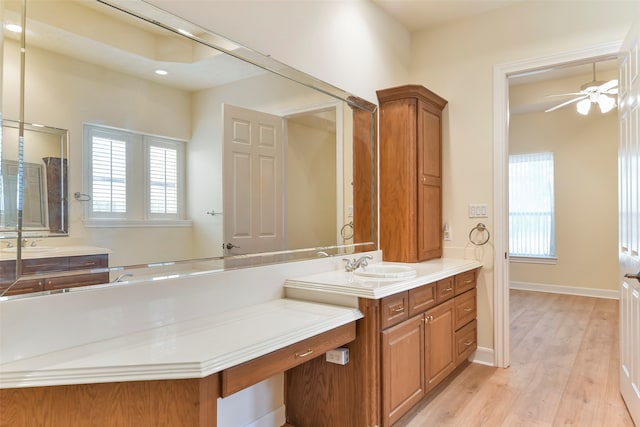 bathroom with ceiling fan, wood-type flooring, and vanity