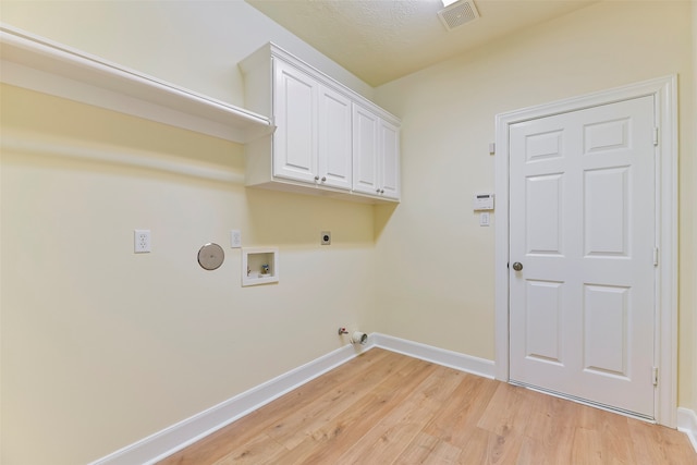 laundry area with washer hookup, hookup for an electric dryer, hookup for a gas dryer, a textured ceiling, and light wood-type flooring