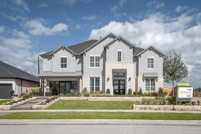 view of front of house with a garage and a front lawn