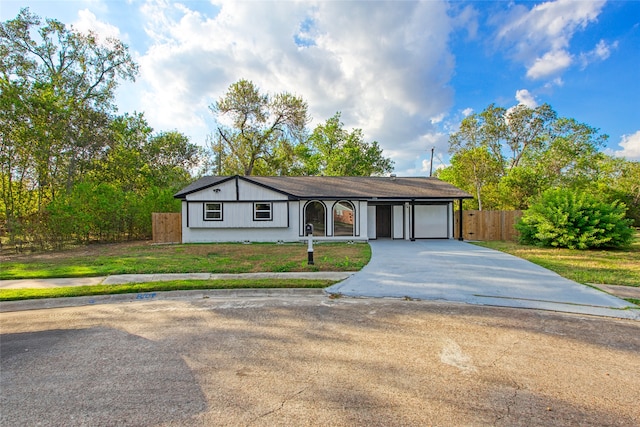 ranch-style home featuring a garage and a front lawn