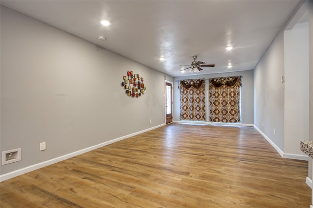 empty room featuring ceiling fan and light wood-type flooring