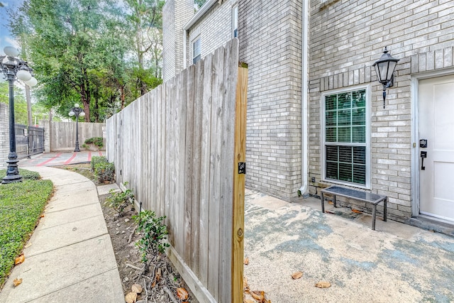 view of exterior entry with a patio area