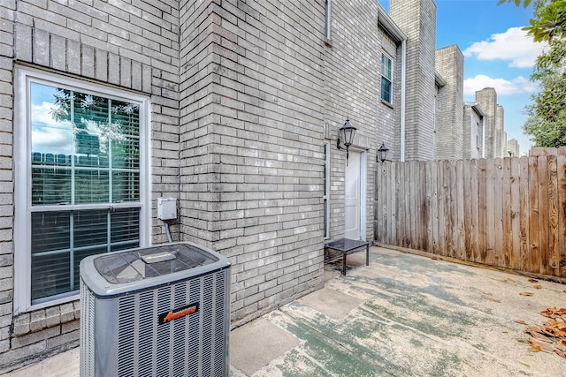 exterior space featuring central air condition unit and a patio