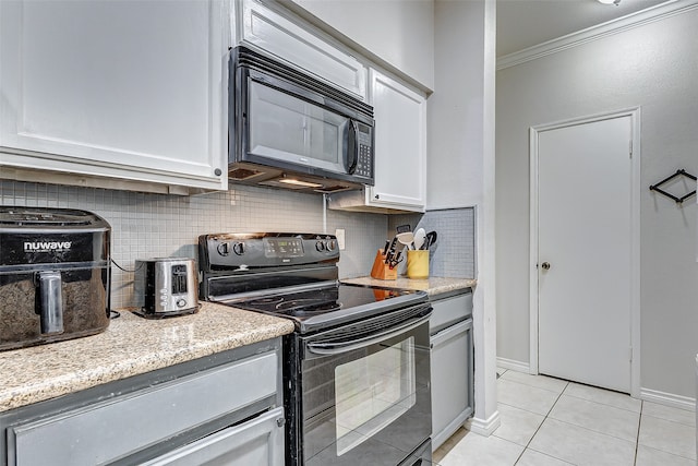 kitchen with white cabinets, backsplash, ornamental molding, light tile patterned flooring, and black appliances