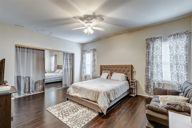 bedroom with dark hardwood / wood-style floors and ceiling fan