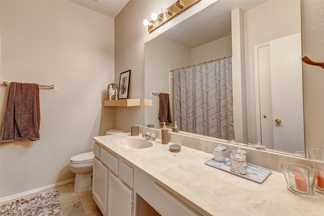 bathroom featuring vanity, toilet, and tile patterned flooring