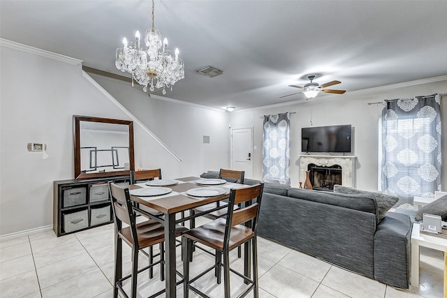 dining room featuring crown molding, light tile patterned floors, and ceiling fan with notable chandelier