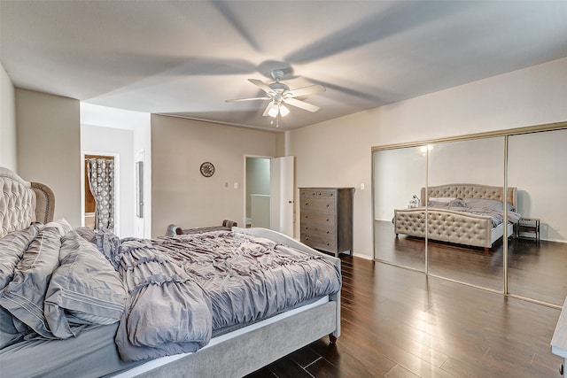 bedroom with dark wood-type flooring, a closet, and ceiling fan