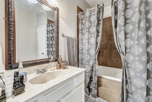 bathroom featuring vanity and shower / bathtub combination with curtain