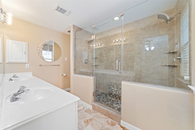 bathroom with a shower with door, vanity, and ceiling fan