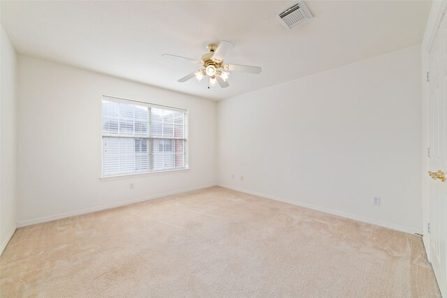 carpeted spare room with ceiling fan