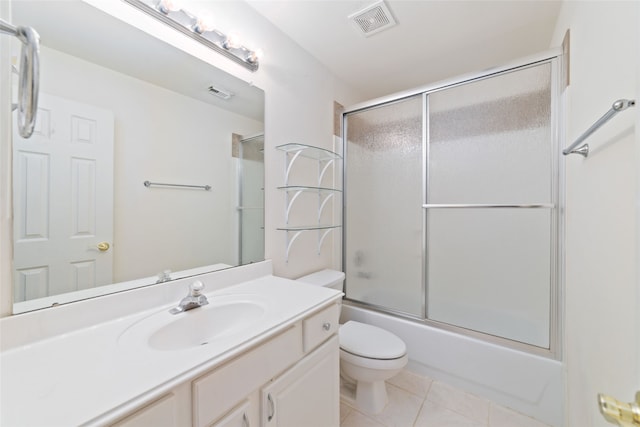 full bathroom with vanity, shower / bath combination with glass door, toilet, and tile patterned flooring