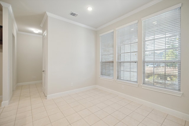 unfurnished room featuring crown molding and light tile patterned floors