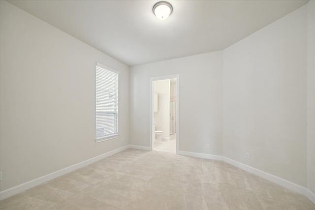 spare room with light colored carpet