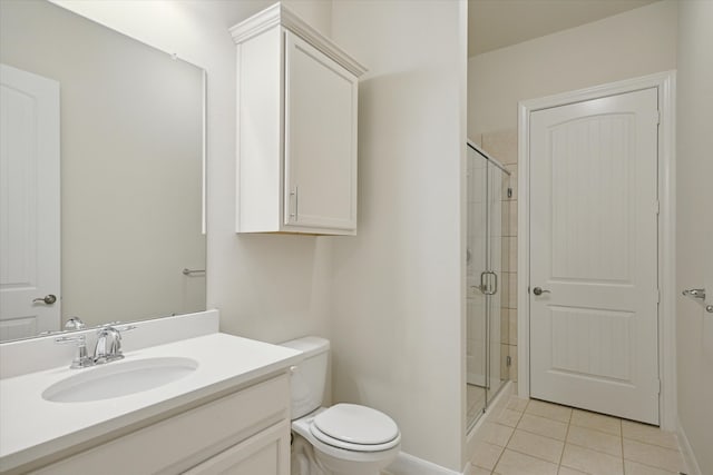 bathroom featuring tile patterned floors, toilet, vanity, and walk in shower