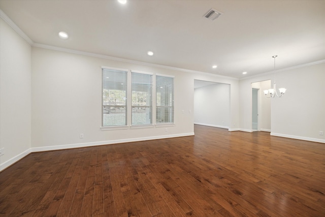 unfurnished room featuring a chandelier, dark hardwood / wood-style floors, and ornamental molding