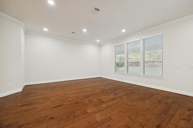 spare room with crown molding and dark hardwood / wood-style floors