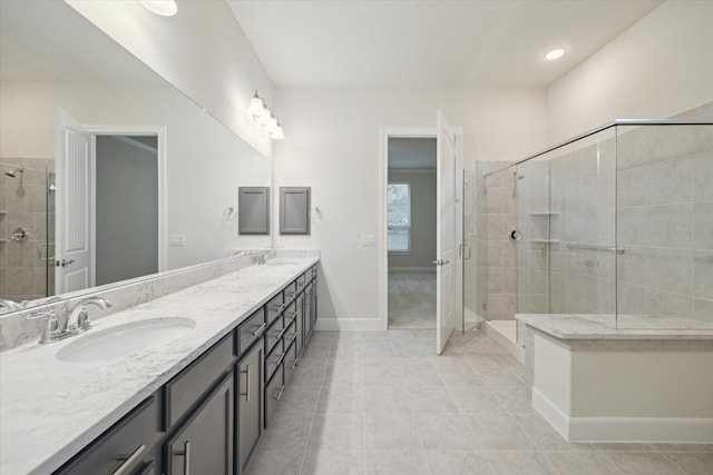 bathroom featuring tile patterned flooring, vanity, and walk in shower