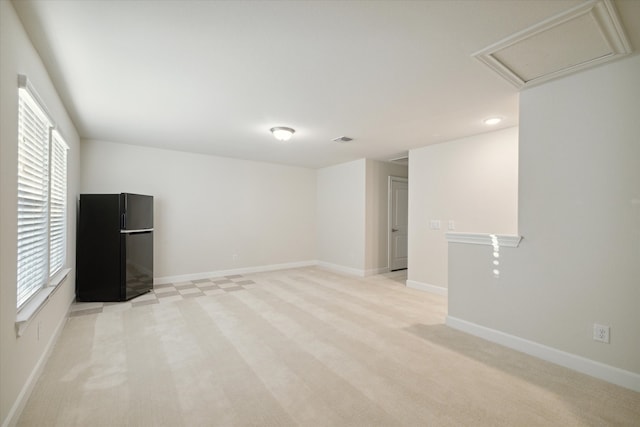 interior space featuring light carpet and plenty of natural light