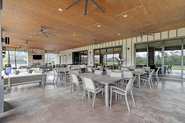 dining space with concrete floors and wood ceiling