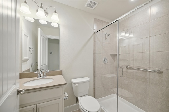 bathroom with vanity, an enclosed shower, and toilet