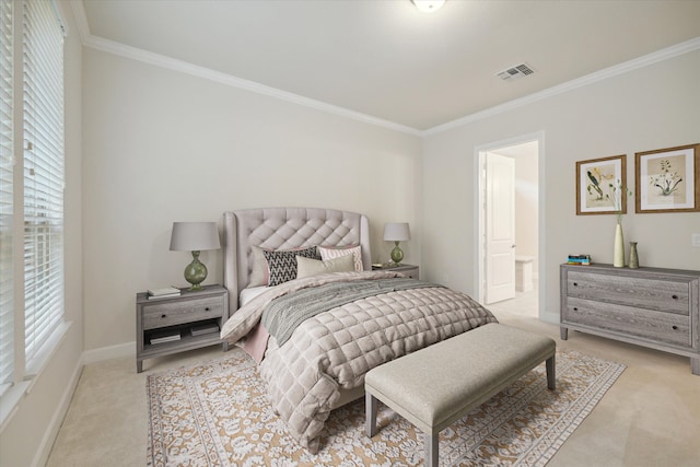 bedroom with ensuite bath, ornamental molding, and light colored carpet