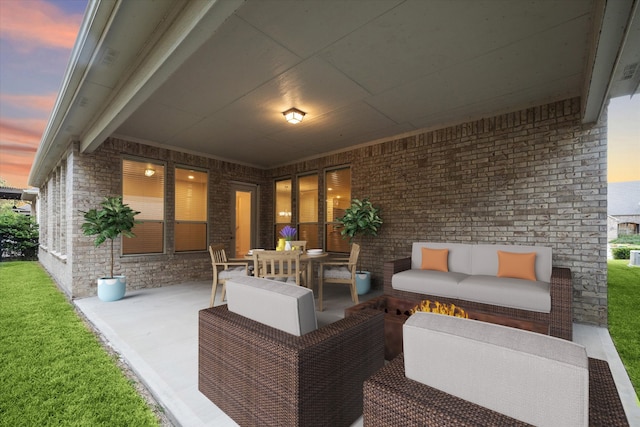 patio terrace at dusk featuring outdoor lounge area