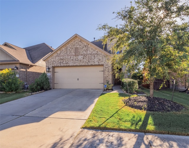 view of front of property with a front yard and a garage