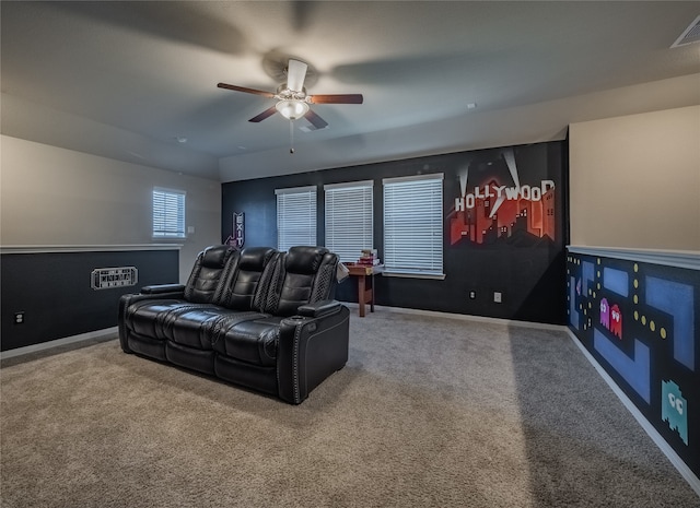 carpeted cinema room featuring ceiling fan