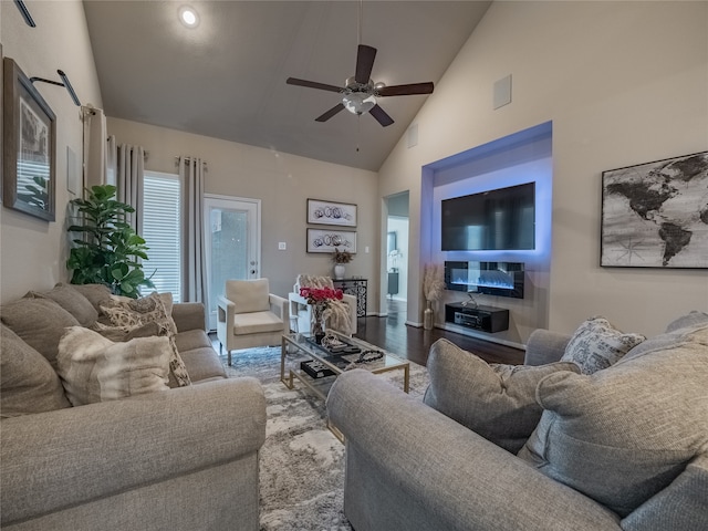 living room featuring hardwood / wood-style floors, high vaulted ceiling, and ceiling fan