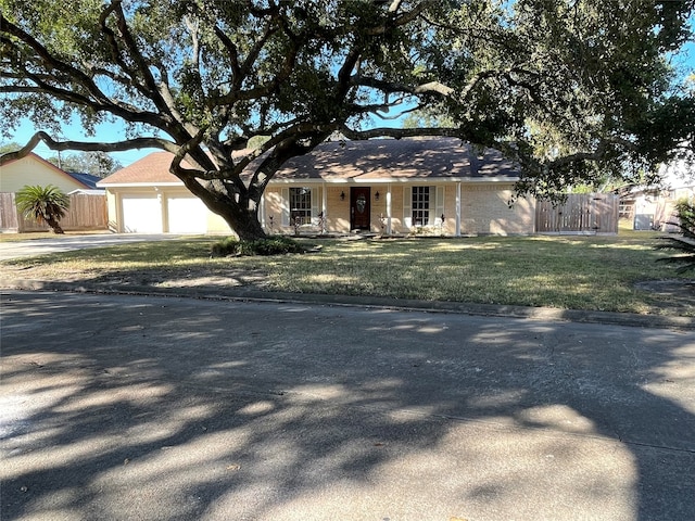 ranch-style house with a front yard and a garage