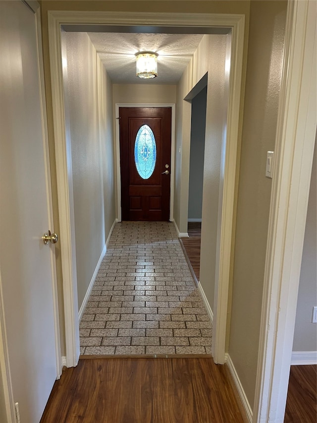 doorway with hardwood / wood-style flooring