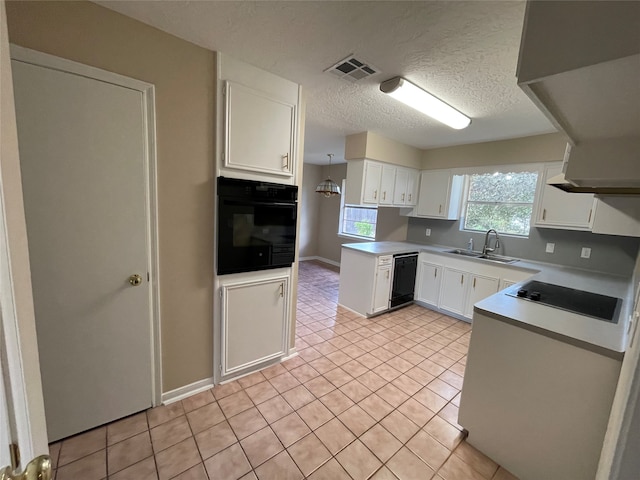 kitchen with white cabinetry, sink, a textured ceiling, light tile patterned floors, and black appliances