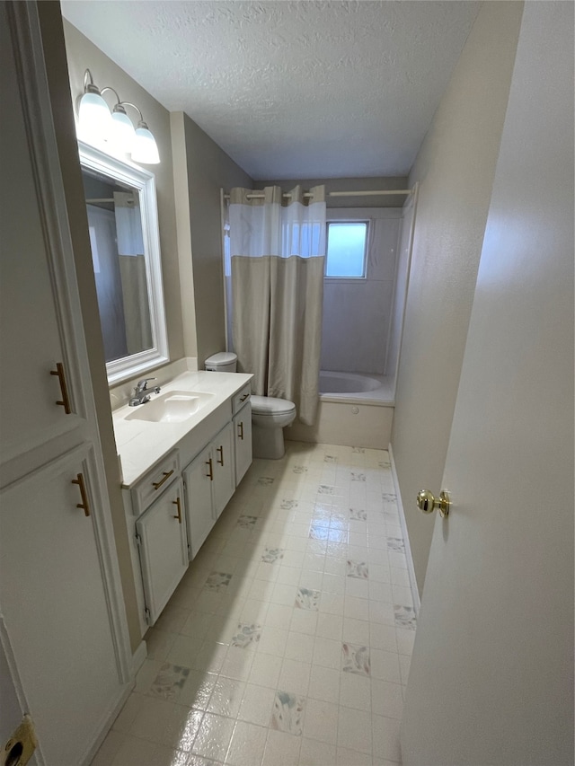 full bathroom with vanity, a textured ceiling, toilet, and shower / bath combo with shower curtain