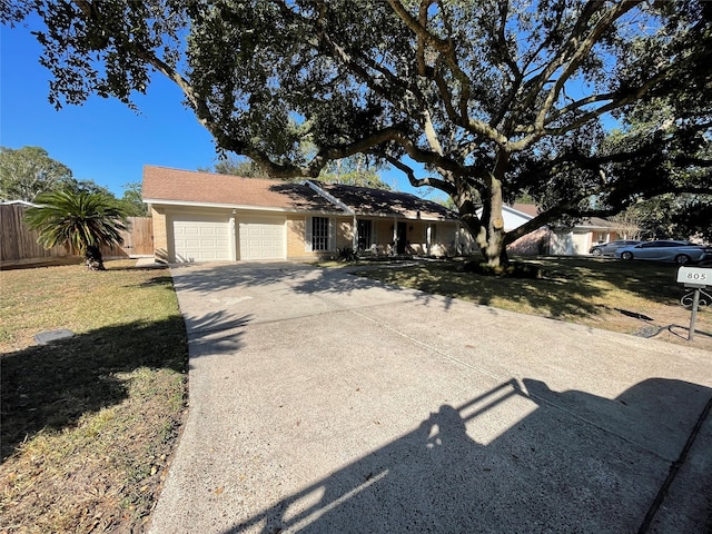 single story home with a front yard and a garage