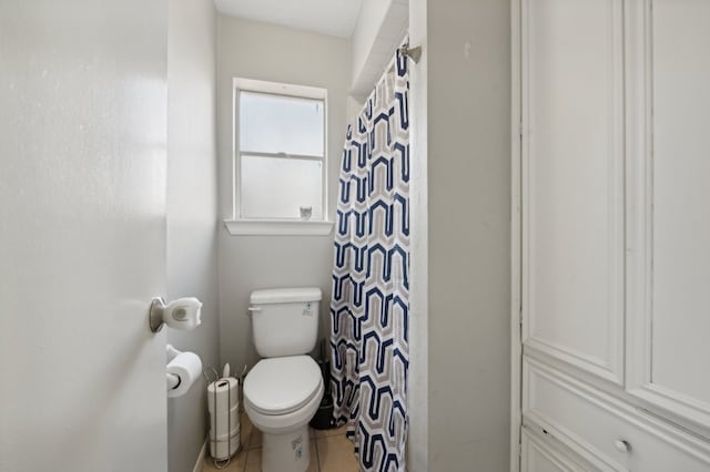 bathroom with toilet, a shower with curtain, and tile patterned flooring