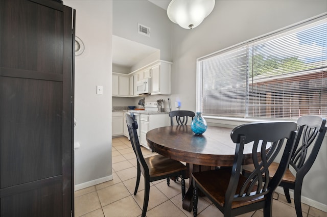 dining area with light tile patterned floors