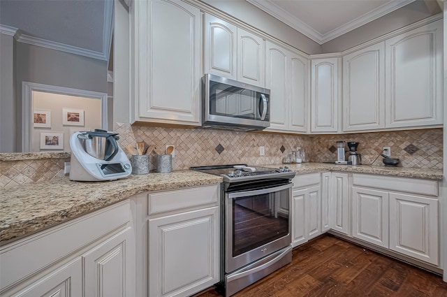 kitchen with decorative backsplash, white cabinets, stainless steel appliances, and dark hardwood / wood-style flooring