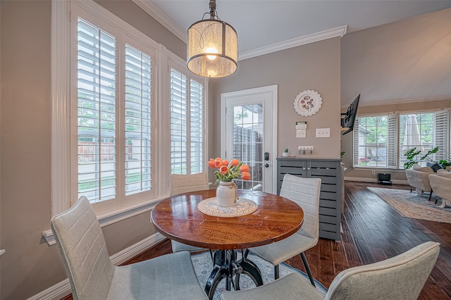 dining area featuring a healthy amount of sunlight, ornamental molding, and dark hardwood / wood-style flooring