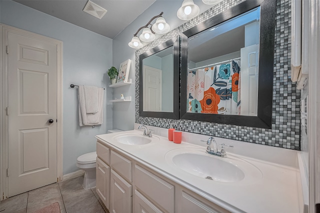 bathroom featuring vanity, toilet, and tile patterned floors