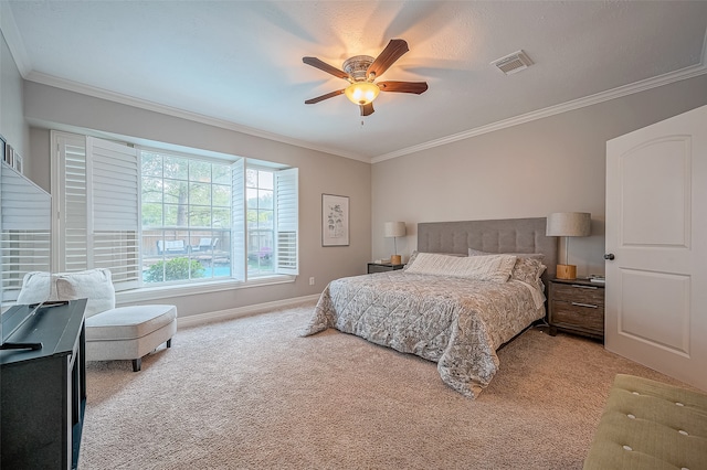 carpeted bedroom featuring ceiling fan and crown molding