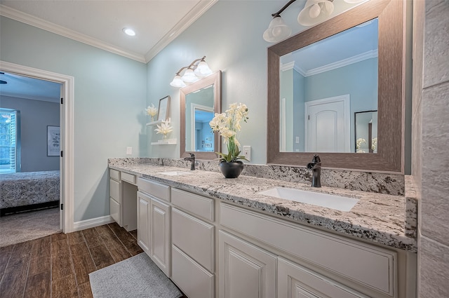 bathroom with vanity, crown molding, and hardwood / wood-style flooring