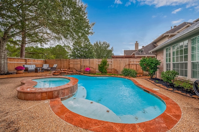 view of swimming pool with an in ground hot tub and a patio area