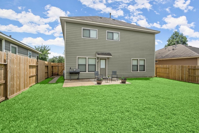 rear view of property featuring a patio area and a lawn