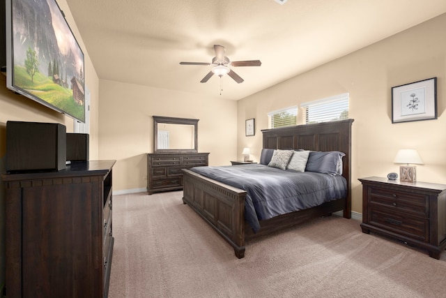 bedroom with ceiling fan and light colored carpet