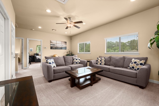 living room with ceiling fan and light colored carpet