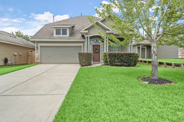 view of front of property featuring a front lawn and a garage