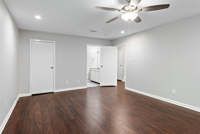 unfurnished bedroom with connected bathroom, a closet, wood-type flooring, and ceiling fan