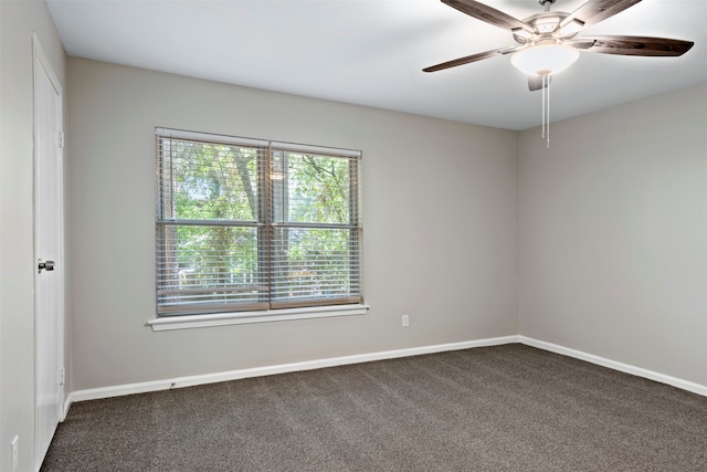 carpeted spare room featuring ceiling fan